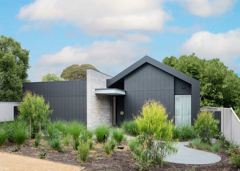 Street-front view of a single-storey home crafted by Melbourne home builders with charcoal exterior
