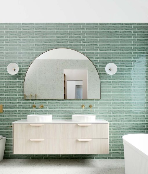 An elegant ensuite bathroom home renovation in Melbourne — showcasing sage subway-tile walls and a floating light-wood vanity.